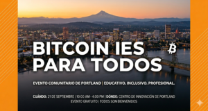 A vista aérea de la ciudad de Portland con el Monte Hood y un texto superpuesto en color blanco y naranja: "BITCOIN IS FOR EVERYONE"
