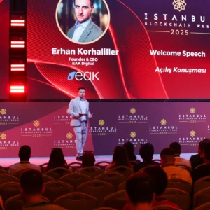 Conferencia de Istanbul Blockchain Week 2025 con Erhan Korhaliller dando el discurso de apertura ante el público.