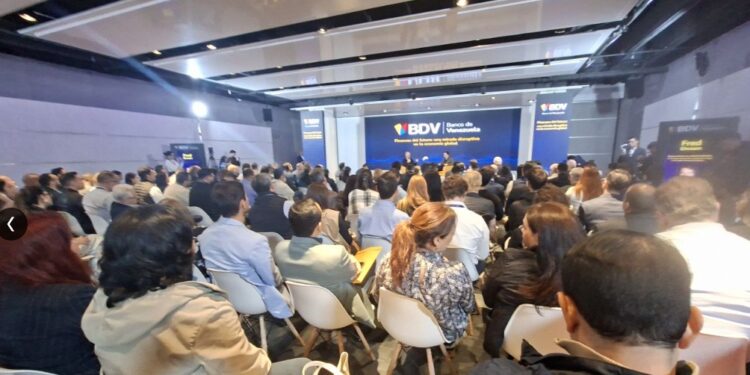 Grupo de personas en un salón escuchando la intervención del cofundador de Coinbase
