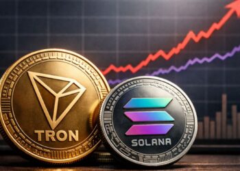 Monedas de Tron y Solana frente a gráfico financiero donde Tron supera a Solana en usuarios activos diarios.