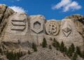 Un monte que tiene tallados los logos de Solana, Chainlink, Bitcoin y Ethereum