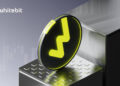 El token WBT, subiendo escalones, en primer plano.