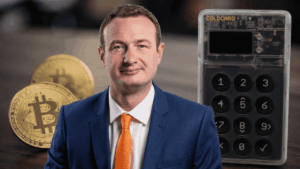Fotografía de Tim Lamb, monedas físicas de bitcoin y una hardware wallet Coldcard.