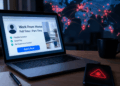 Laptop con falsa oferta laboral y celular infectado, mientras un mapa mundial refleja el alcance de una campaña de malware.