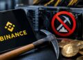 Tablet con el logo de Binance junto a monedas de bitcoin y criptomonedas, un pico y un símbolo de prohibido sobre un equipo de minería.