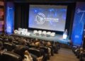 Público en el auditorio de Blockchain Summit Latam en Lima, frente a la pantalla con el logo del evento