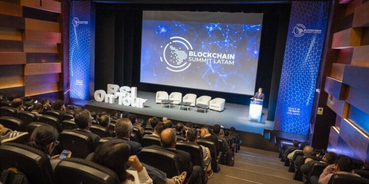 Público en el auditorio de Blockchain Summit Latam en Lima, frente a la pantalla con el logo del evento