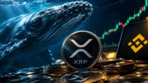 Moneda de criptomoneda XRP de Ripple junto a una ballena bajo el agua y gráficos del mercado.